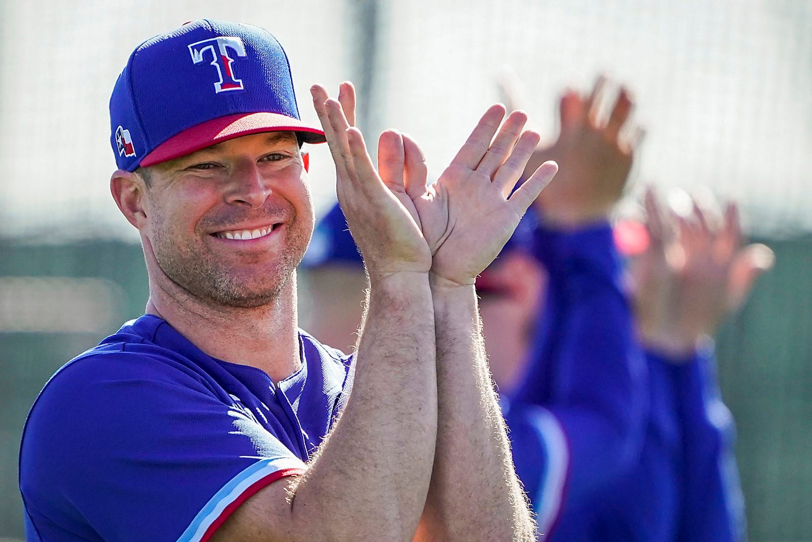 Texas Rangers pitcher Corey Kluber stretches with teammates during a training workout at the...