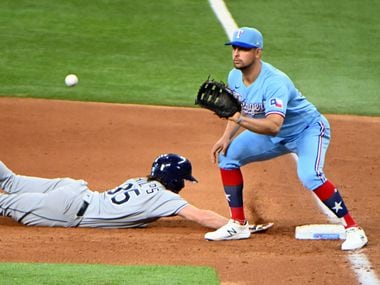 Texas Rangers first baseman Nate Lowe (30) waits on the throw on a pickoff attempt of Tampa Bay Rays right fielder Brett Phillips (35) in the third inning during a MLB game, Sunday, June 6, 2021, in Arlington, Texas.
