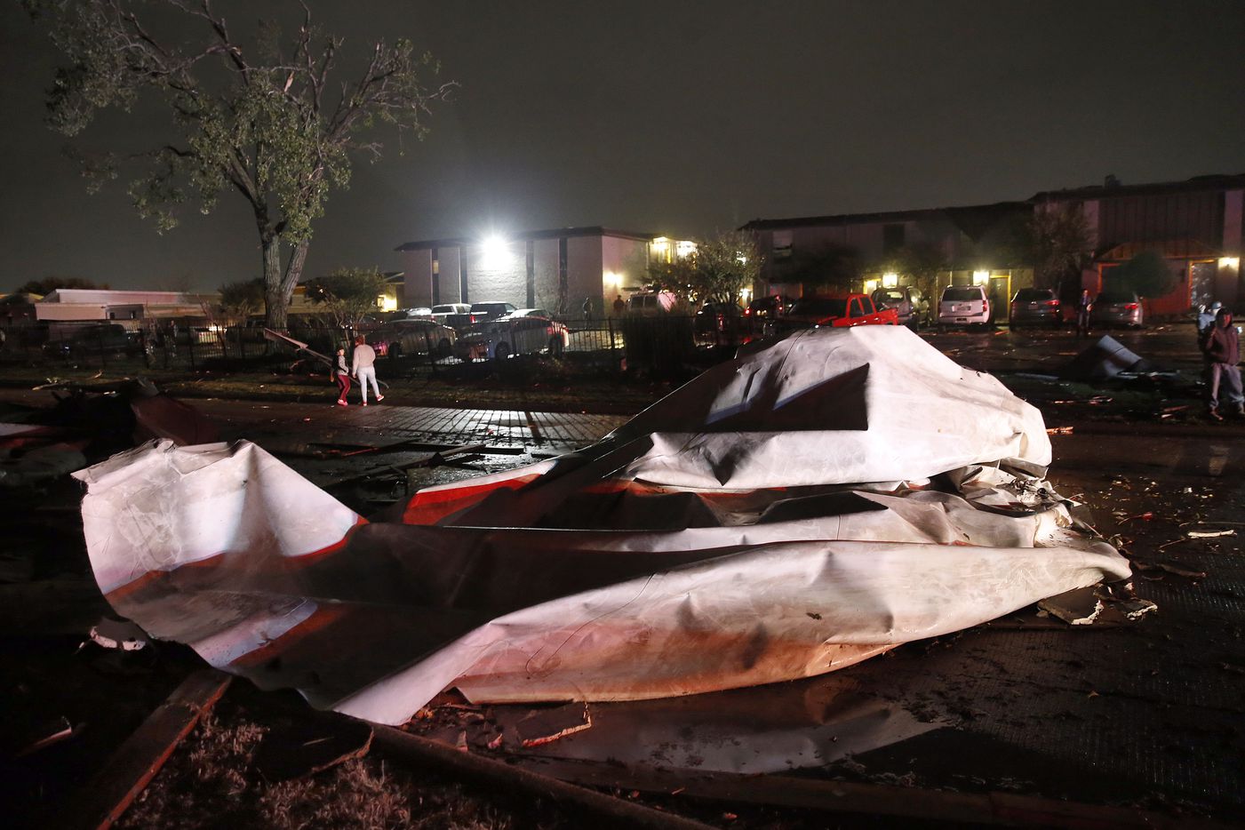 Roofs from The Mirage Apartments complex were torn off and landed on Pioneer Parkway in Arlington following a tornado-warned storm, Tuesday night, November 24, 2020. Air conditioner units and other structural debris were scattered across the property.
