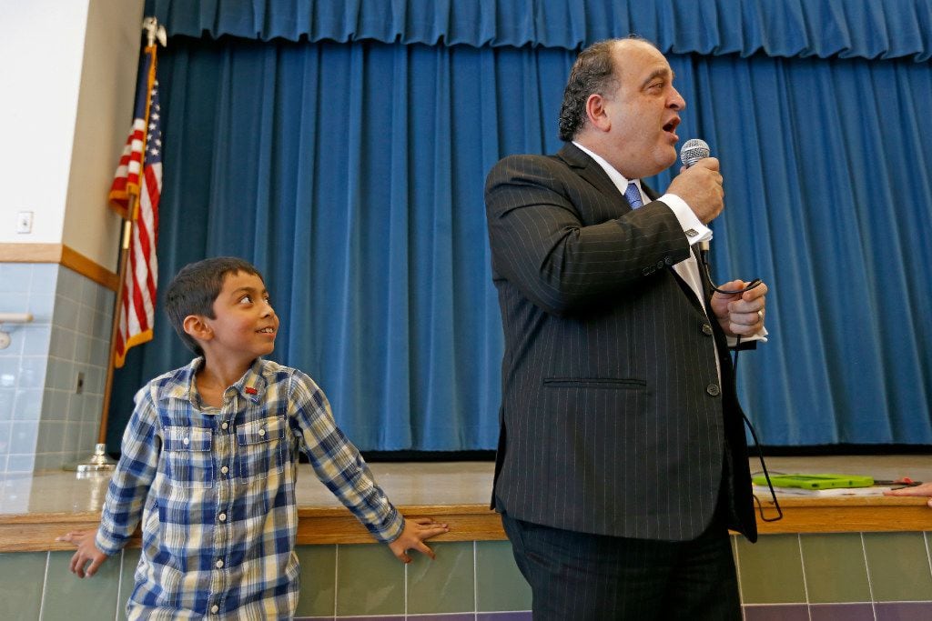 Mayor Maher Maso briefly speaks to second-graders as Ian Bolanos, 8, looks on in the school...