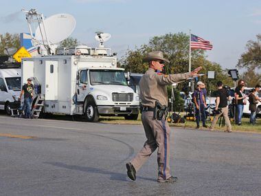 A Texas state trooper directs traffic at the intersection near the First Baptist Church of...