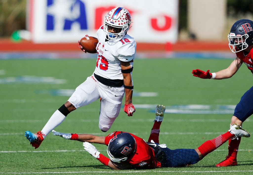 Parish Episcopal's Kaleb Culp (19) leaps over Plano John Paul II's Cameron Peters (8) during the first half of play at the TAPPS Division I state championship game at Waco Midway's Panther Stadium in Hewitt, Texas on Friday, December 6, 2019. (Vernon Bryant/The Dallas Morning News)