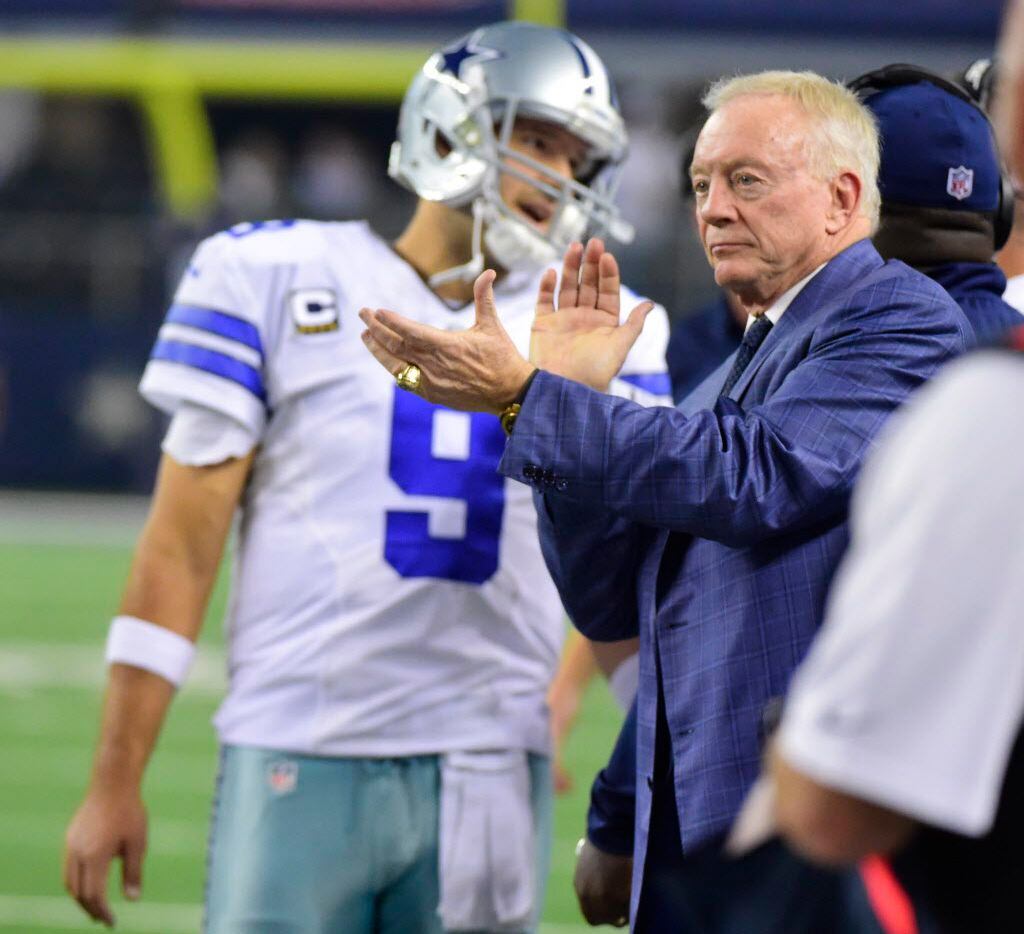 Dallas Cowboys owner Jerry Jones cheers from the sideline as Tony Romo prepared to enter the...