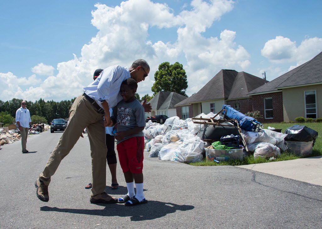 President Barack Obama spoke with residents as he toured a flood-damaged area in Baton Rouge...