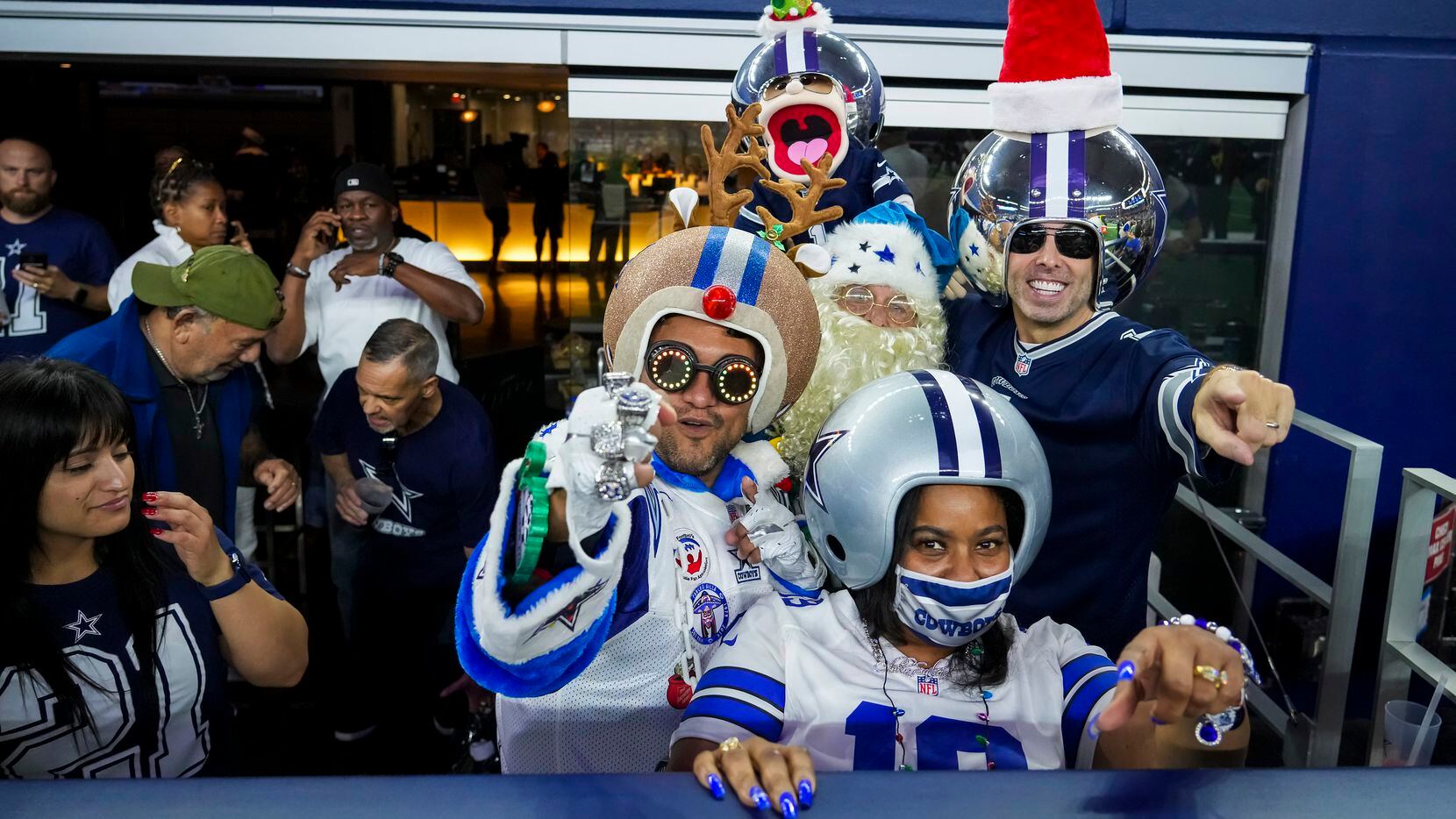 Dallas Cowboys fans cheer as the team warms up before an NFL football game against the Washington Football Team at AT&T Stadium on Sunday, Dec. 26, 2021, in Arlington.