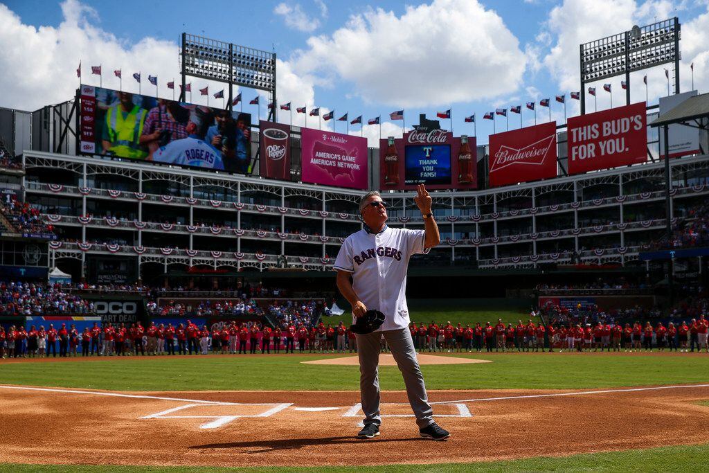 Former Texas Rangers player  Kenny Rogers waves to fans as he is introduced to catch the...