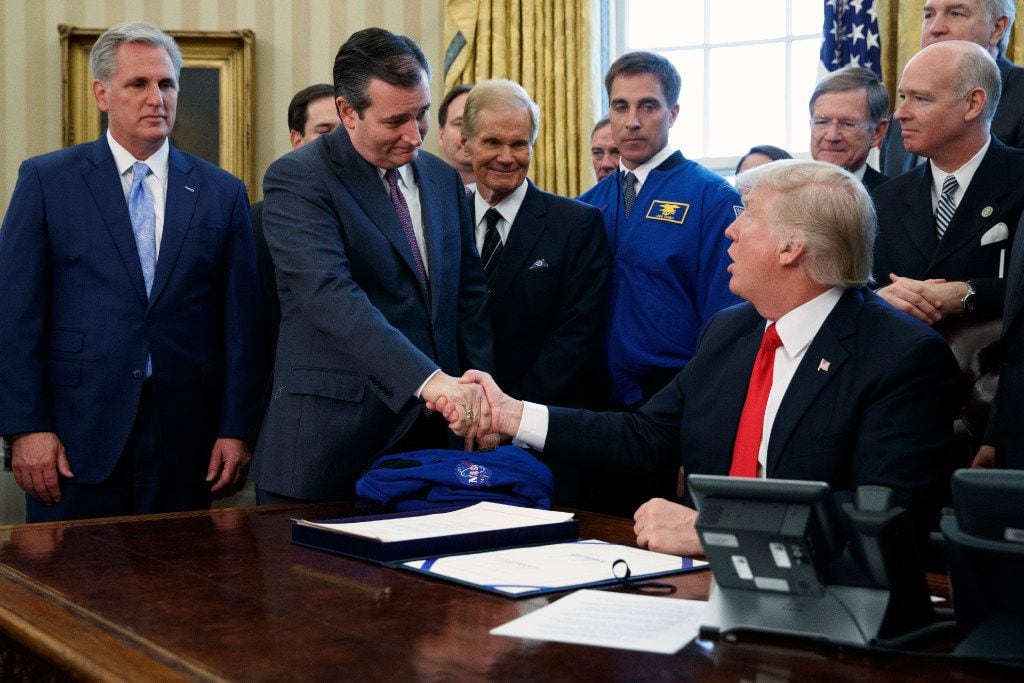 President Donald Trump shook hands with Sen. Ted Cruz, R-Texas, flanked by House Majority...