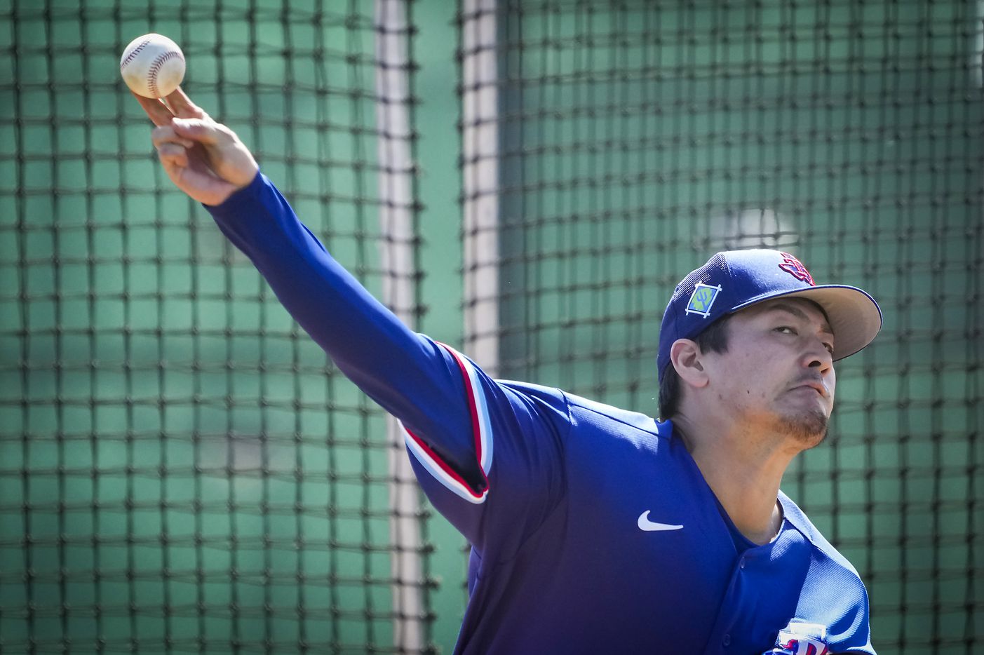 Texas Rangers pitcher Kohei Arihara throws live batting practice during a spring training...