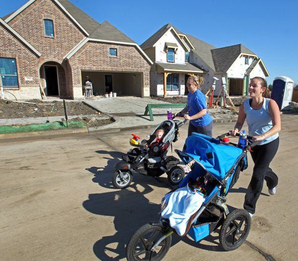 Jessica Thompson (right) and Ashley Crews go for a morning jog in the Woodcreek subdivision in Fate, where new houses are springing up. Census data showed the Rockwall County city grew at the fastest rate of any in the state in the last decade, with its population rising from 497 in 2000 to 6,,357 in 2010.
