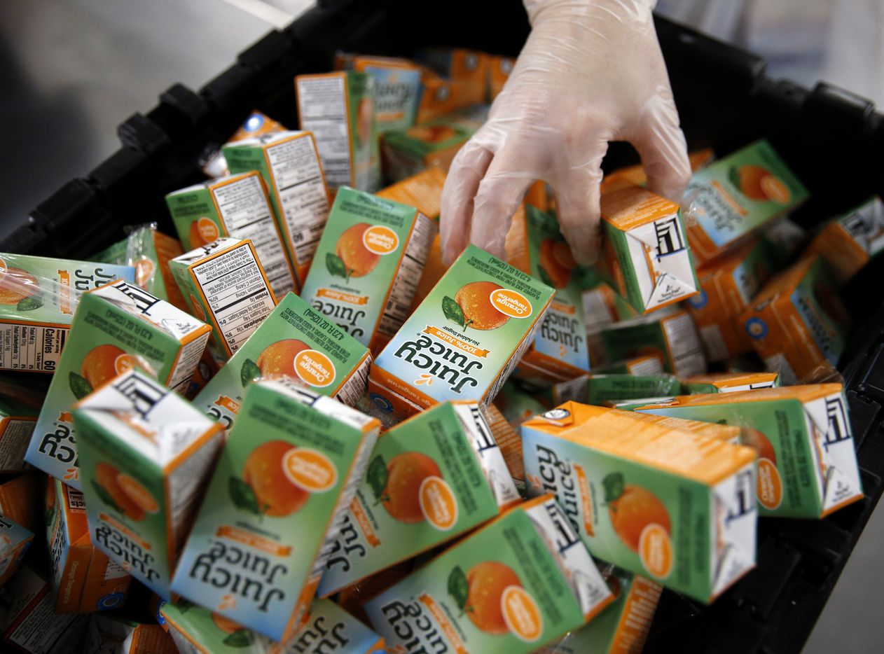 Juice boxes, along with other food items, will be packed into boxes at the North Texas Food...