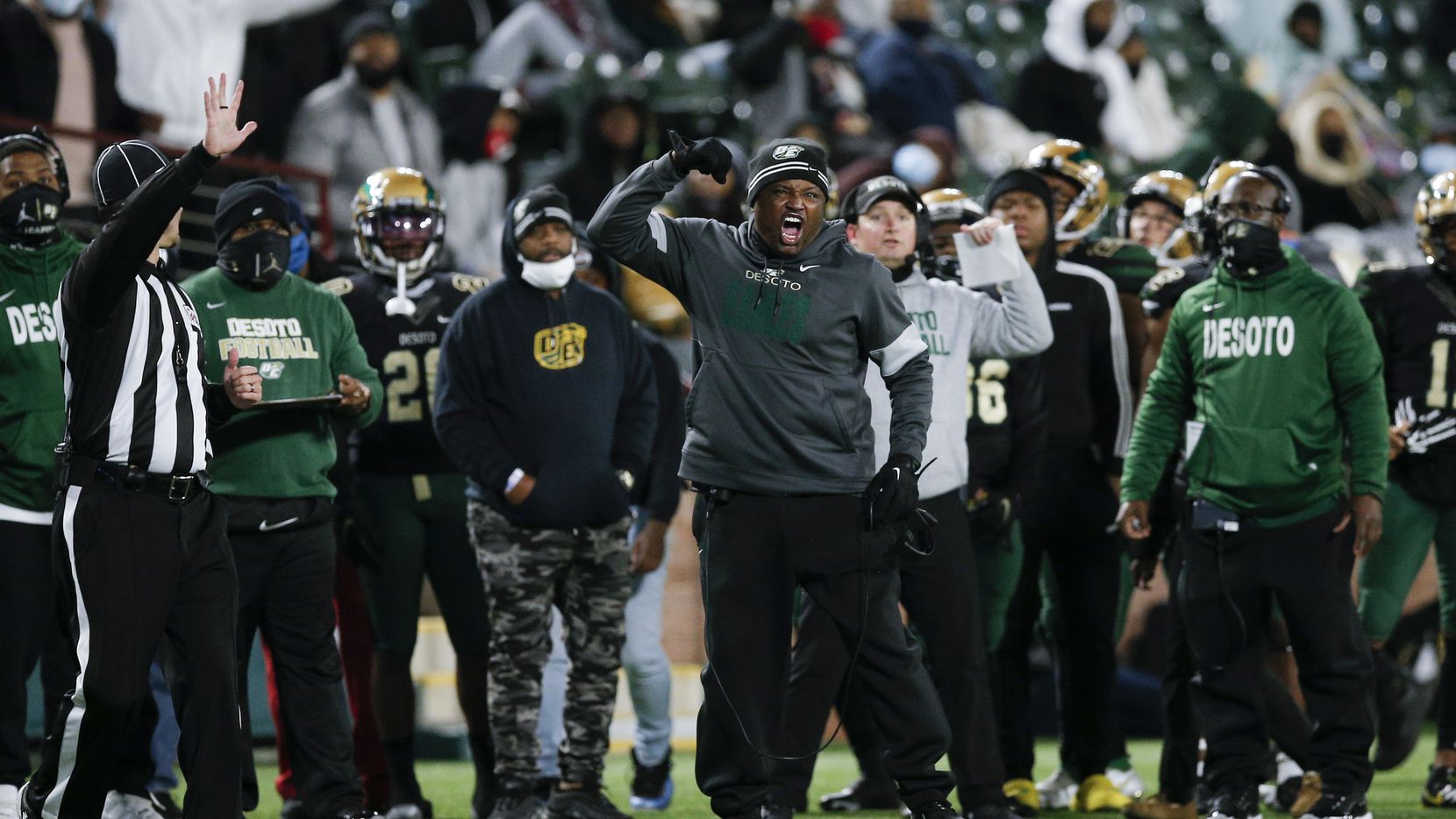 DeSoto head coach Claude Mathis, center, argues for a call during the first half of a Class...