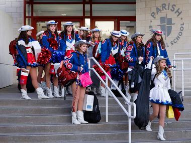 Officers and line members of Parish High School Rosettes drill team make their way to board...
