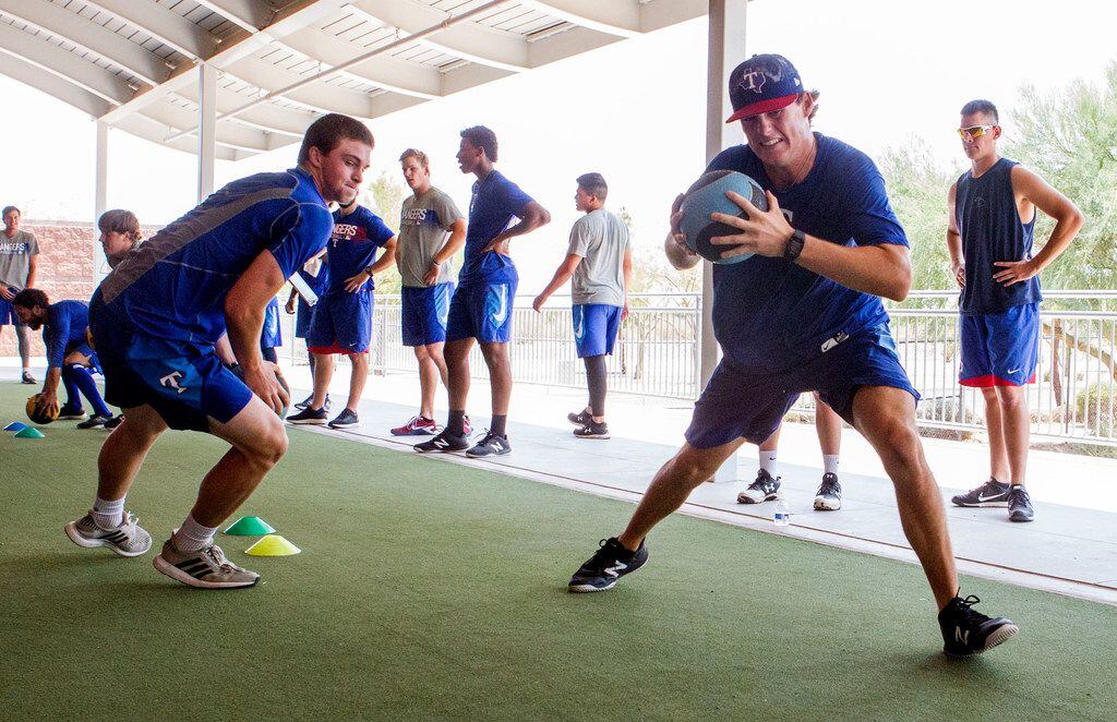 Texas Rangers' pitcher Mason Englert (right) does a drill against Wyatt Sparks(left) that...