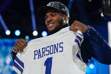 Penn State linebacker Micah Parsons holds a team jersey after the was chosen by the Dallas...