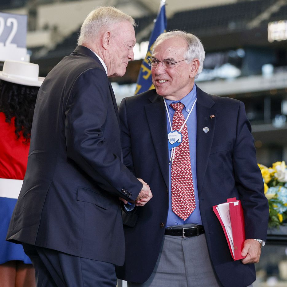 Dallas Cowboys owner Jerry Jones shakes hands with emcee Brad Sham during the Cotton Bowl Hall of Fame induction ceremony at AT&T Stadium on Tuesday, Oct. 5, 2021, in Arlington. (Elias Valverde II/The Dallas Morning News)