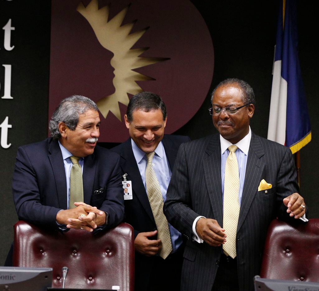 Interim superintendent Michael Hinojosa (far left) talks to trustees Edwin Flores and Lew Blackburn before Dallas ISD board of trustees name Hinojosa as the sole finalist for the superintendent's job in Sept. 15, 2015.