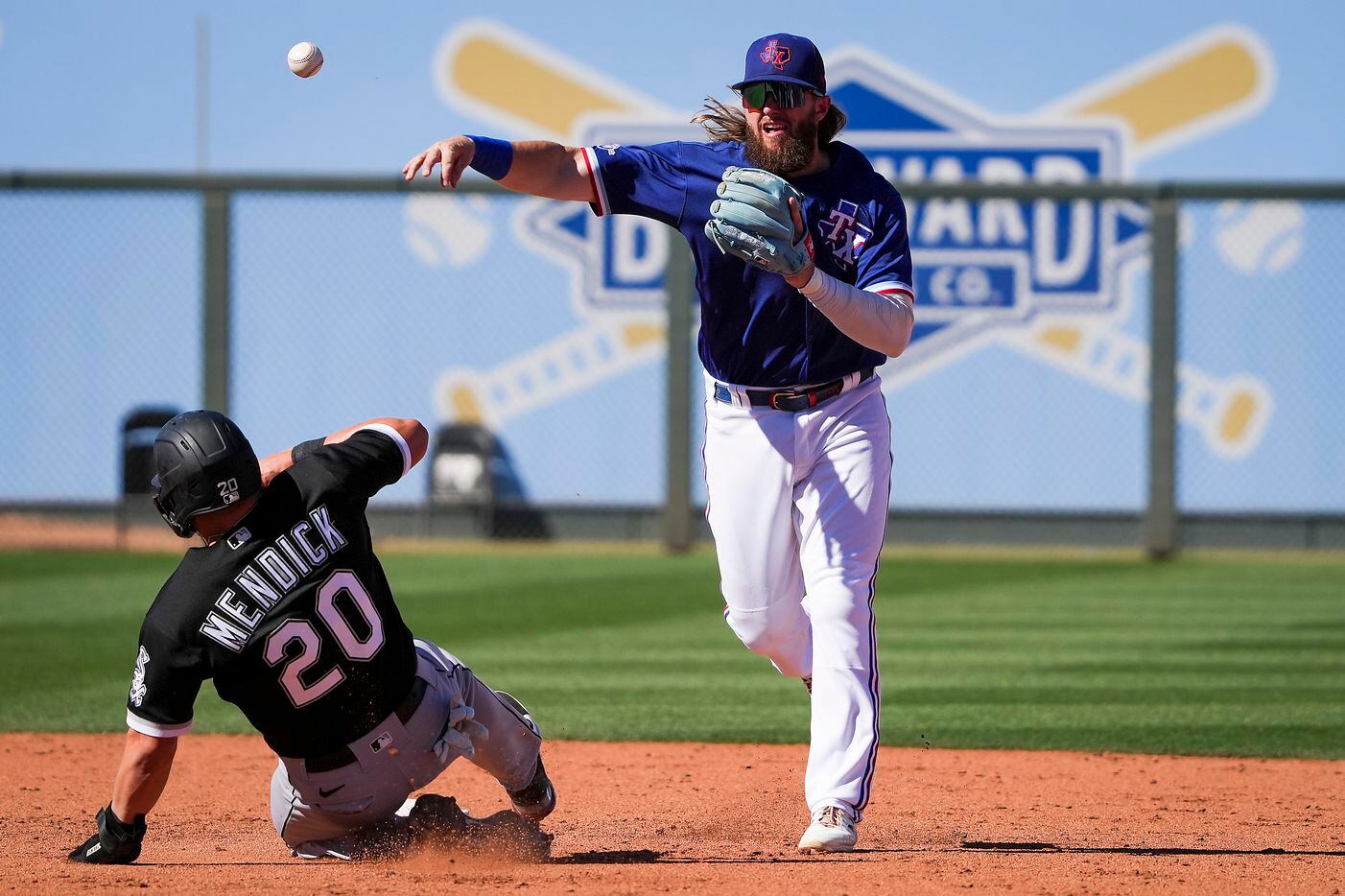 Texas Rangers shortstop Davis Wendzel makes the relay on a double play over Chicago White...