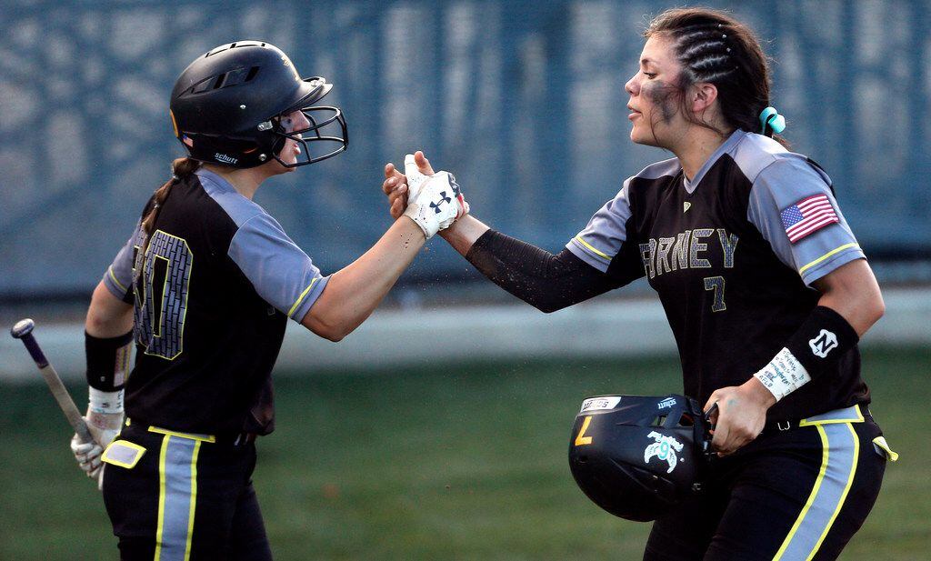 Forney sophomore Trinity Cannon (7) is congratulated by senior Caroline Tedder (30) after scoring on an RBI double hit by sophomore Savanna DesRochers (2) during the first inning of a high school softball game 1 of a best-of-3 Class 5A Region II semifinal against Mansfield Lake Ridge at Lake Ridge High School in Mansfield, Thursday, May 17, 2018. (Brandon Wade/Special Contributor)