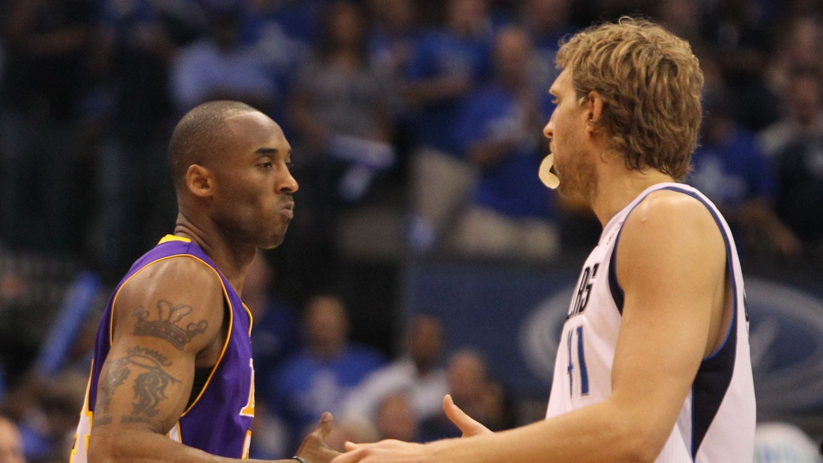 Los Angeles' Kobe Bryant and Dallas' Dirk Nowitzki shake hands before during Game 4 of the...