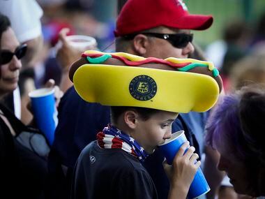 A young fan wears a foam hotdog hat during the first inning of the Round Rock Express season...