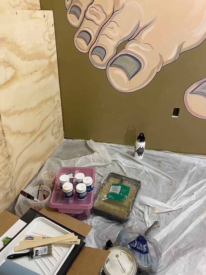 Yana Payusova's in-progress work at Meow Wolf is a large wall art of large bare feet...