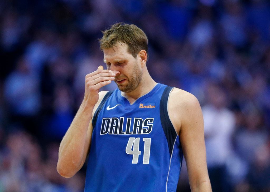Dallas Mavericks forward Dirk Nowitzki (41) gets emotional after a video played during a...
