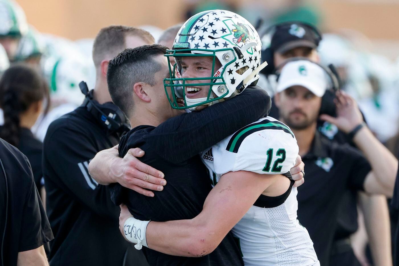 Southlake quarterback Kaden Anderson (12) is hugged by coach Riley Dodge during the second half of a Class 6A Division I Region I final high school football game against Allen,  in Denton, Texas on Saturday, Dec. 4, 2021. Southlake defeated Allen 47-21. (Michael Ainsworth/Special Contributor)
