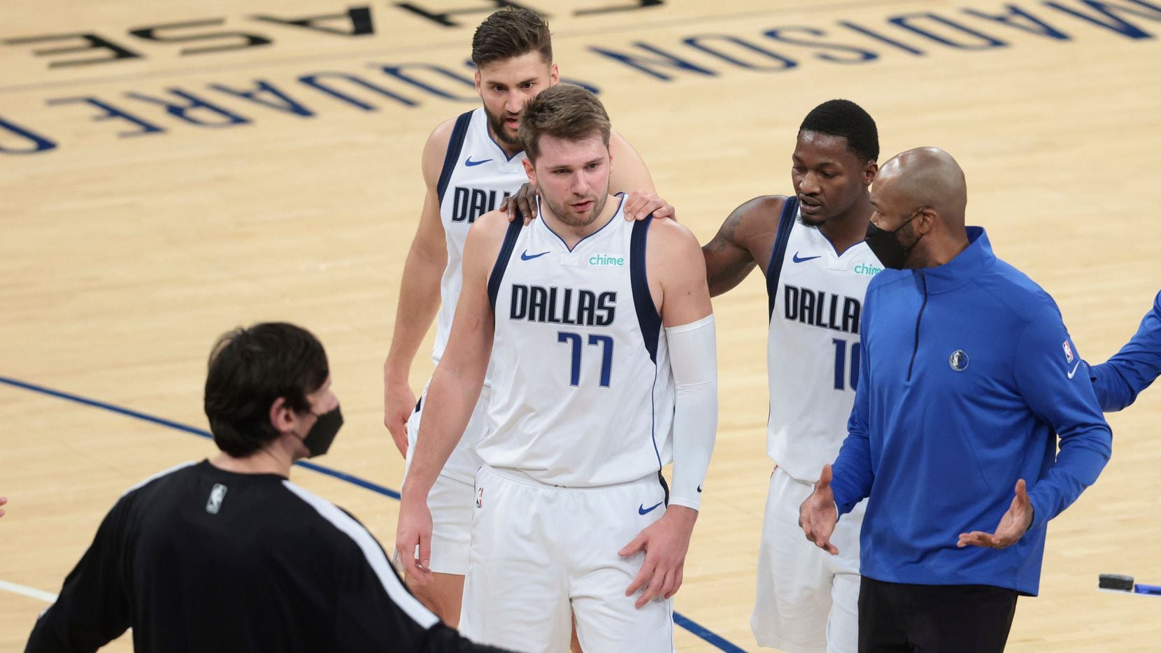 Dallas Mavericks guard Luka Doncic (77) talks with assistant coach Jamahl Mosley and teammates during the second half against the New York Knicks in an NBA basketball game Friday, April 2, 2021, in New York.