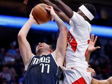 Dallas Mavericks guard Luka Doncic (77) is fouled by Toronto Raptors forward Chris Boucher...