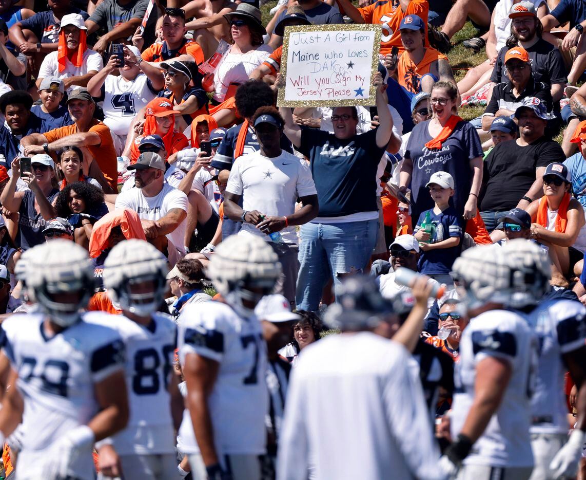 A Dallas Cowboys fan asks for quarterback Dak Prescott’s autograph on her jersey before a...