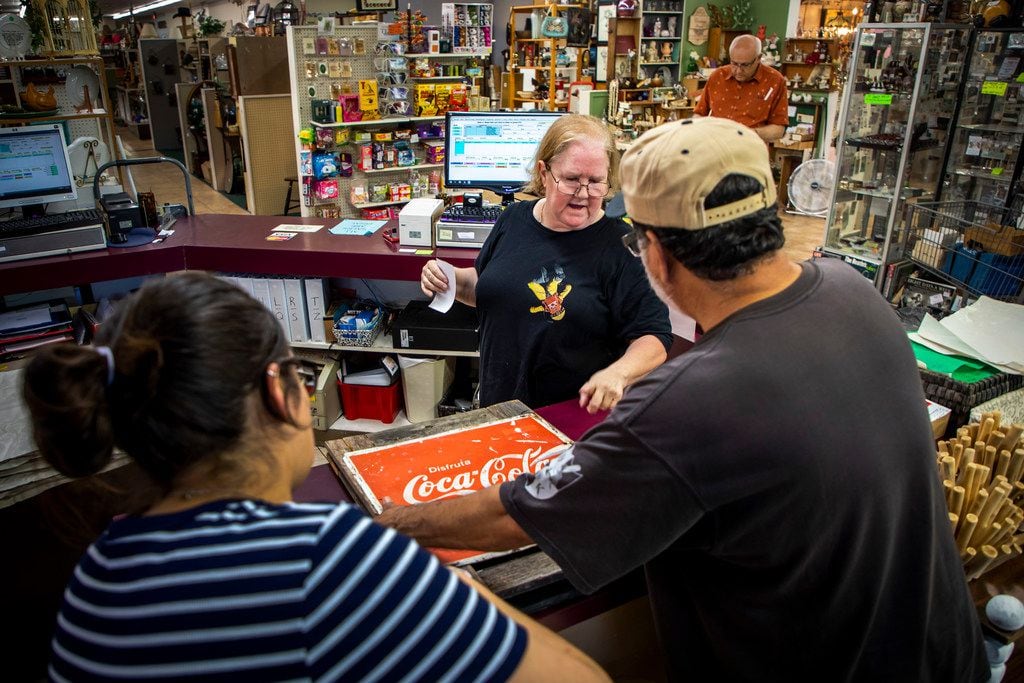 Geralyn Hill, assistant manager of Plano Antique Mall, assists customers.