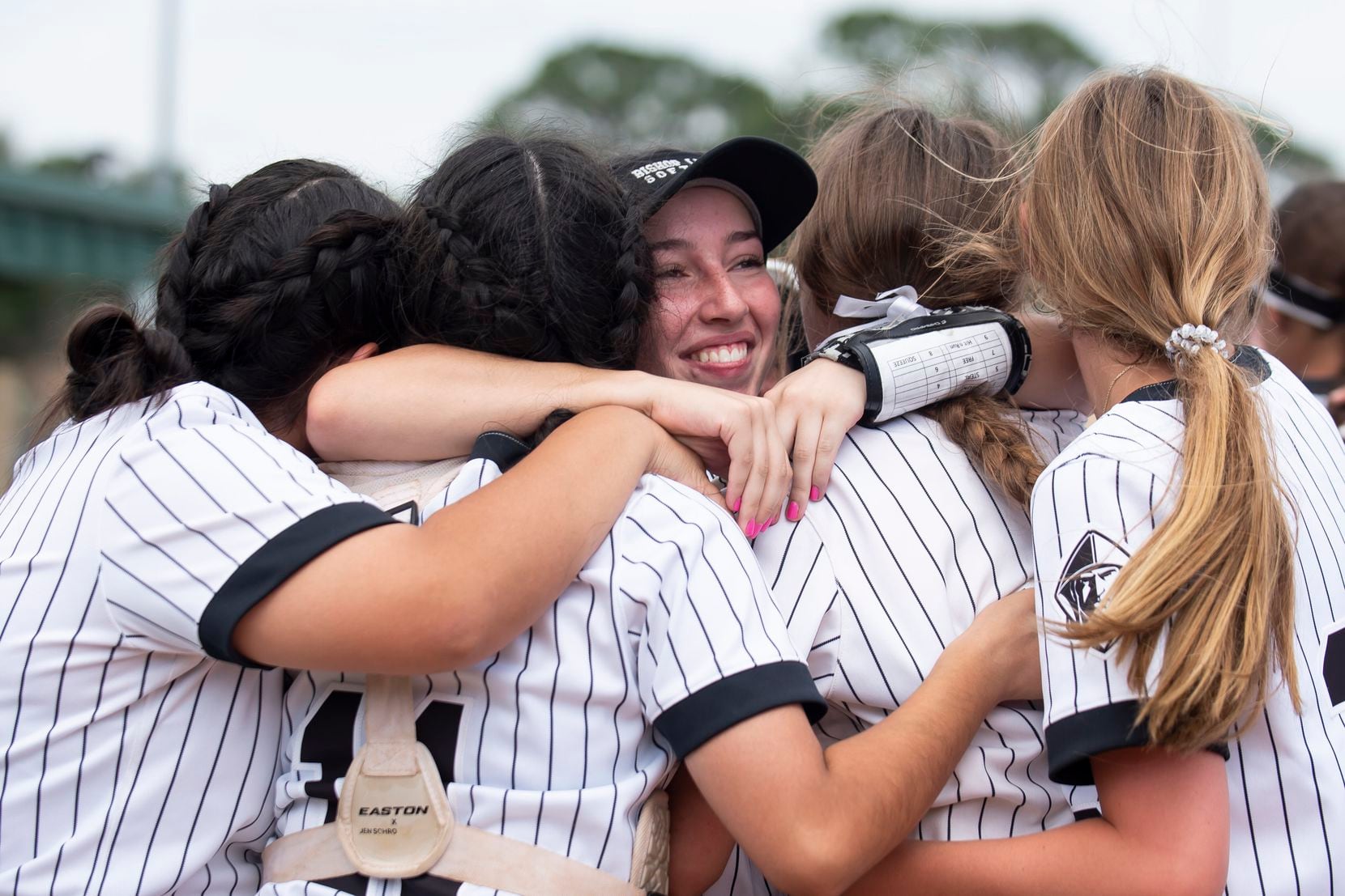 Bishop Lynch sophomore Corina Hernandez (10) embraces her teammates after winning the TAPPS...