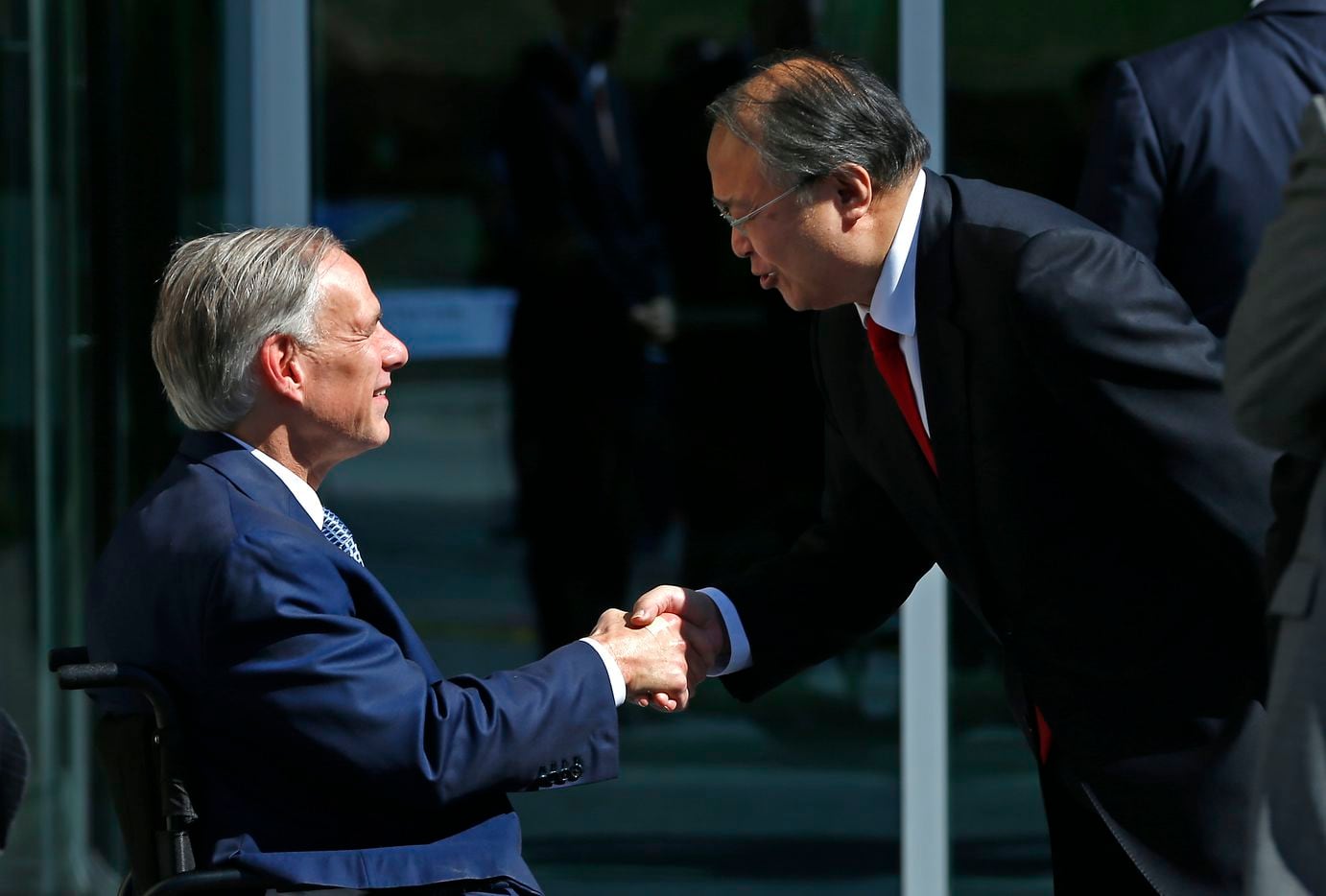 Texas Gov. Greg Abbott shakes hands with Consulate-General of Japan Teruo Amano during a...