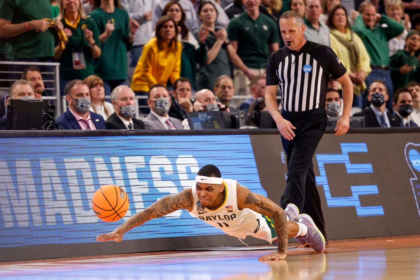 Baylor Bears guard James Akinjo (11) dives for a loose ball during the second half of a...