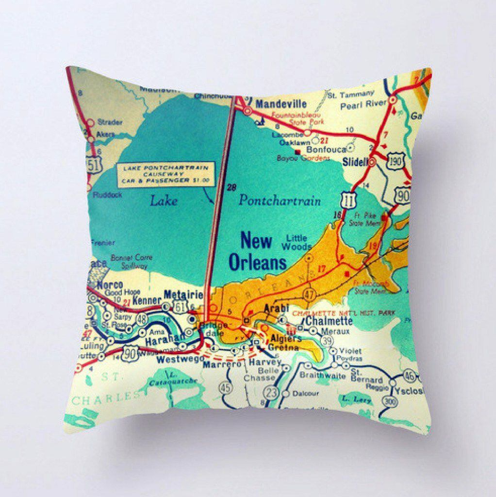 Bright tropical colors make Vintage Beach Maps' pillows stand out on a couch. Pick your...