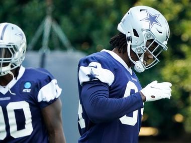 Dallas Cowboys defensive end Randy Gregory (94) laughs between drills with teammate DeMarcus Lawrence (90)during the team's practice at The Star on Wednesday, Oct. 7, 2020, in Frisco.