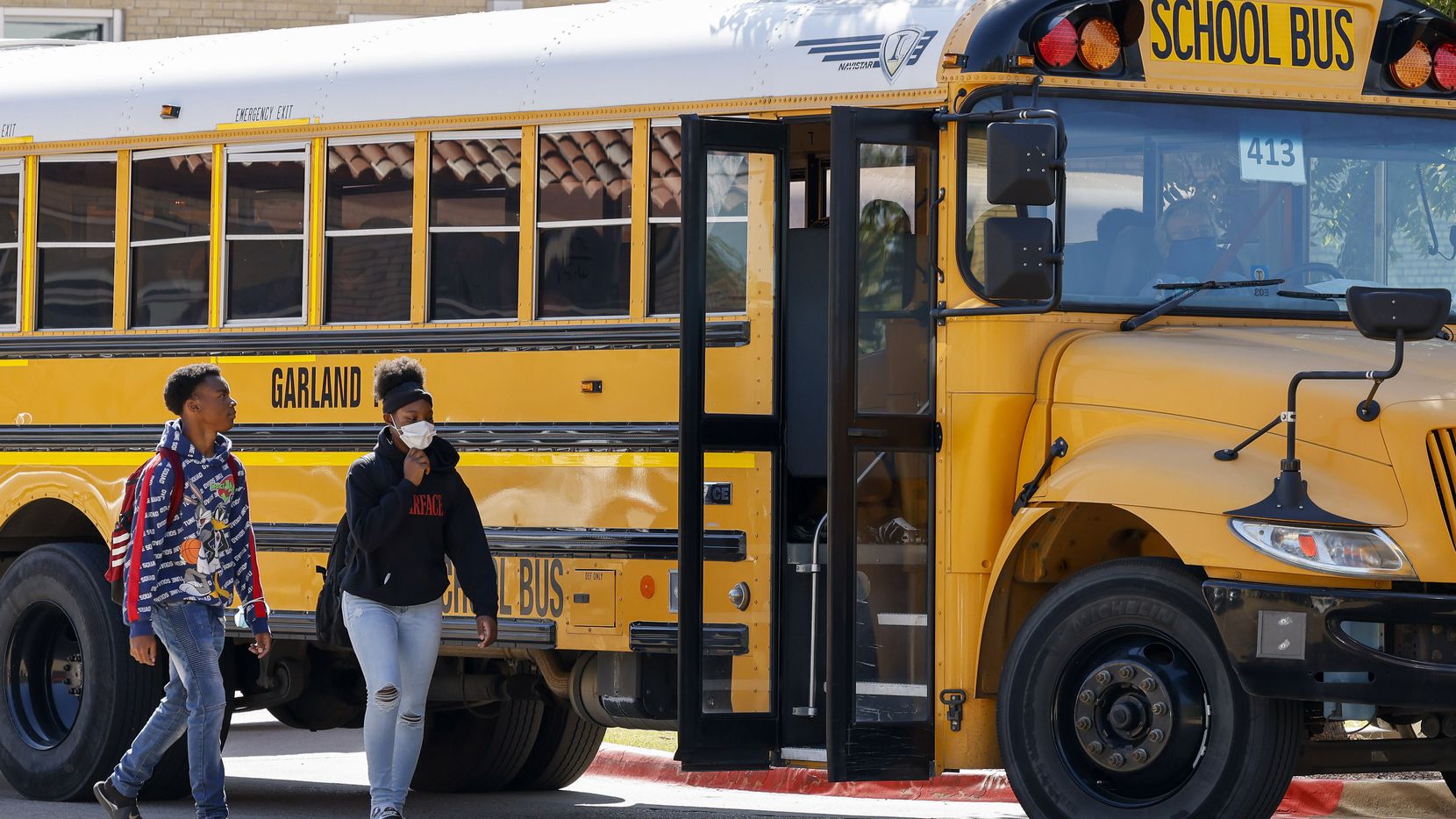 Students boarded a Garland ISD bus outside Garland High School on Oct. 22, 2021.
