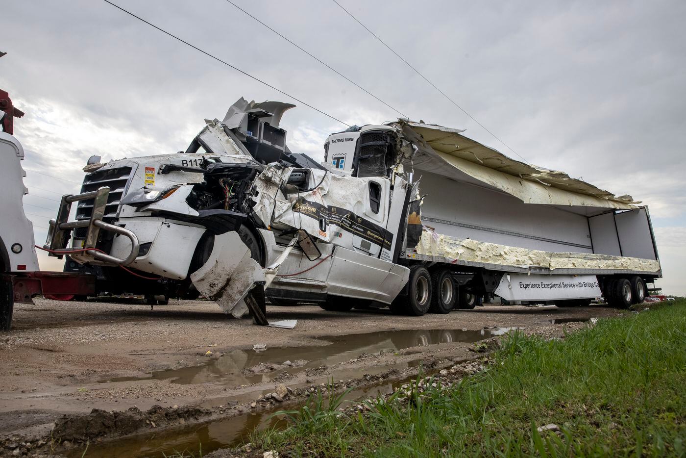 An 18-wheeler is hitched up to a tow truck after being damaged on Interstate 35 in the Monday night tornado that touched down just south of in Waxahachie, Texas, on Tuesday, May 4, 2021. (Lynda M. González/The Dallas Morning News)