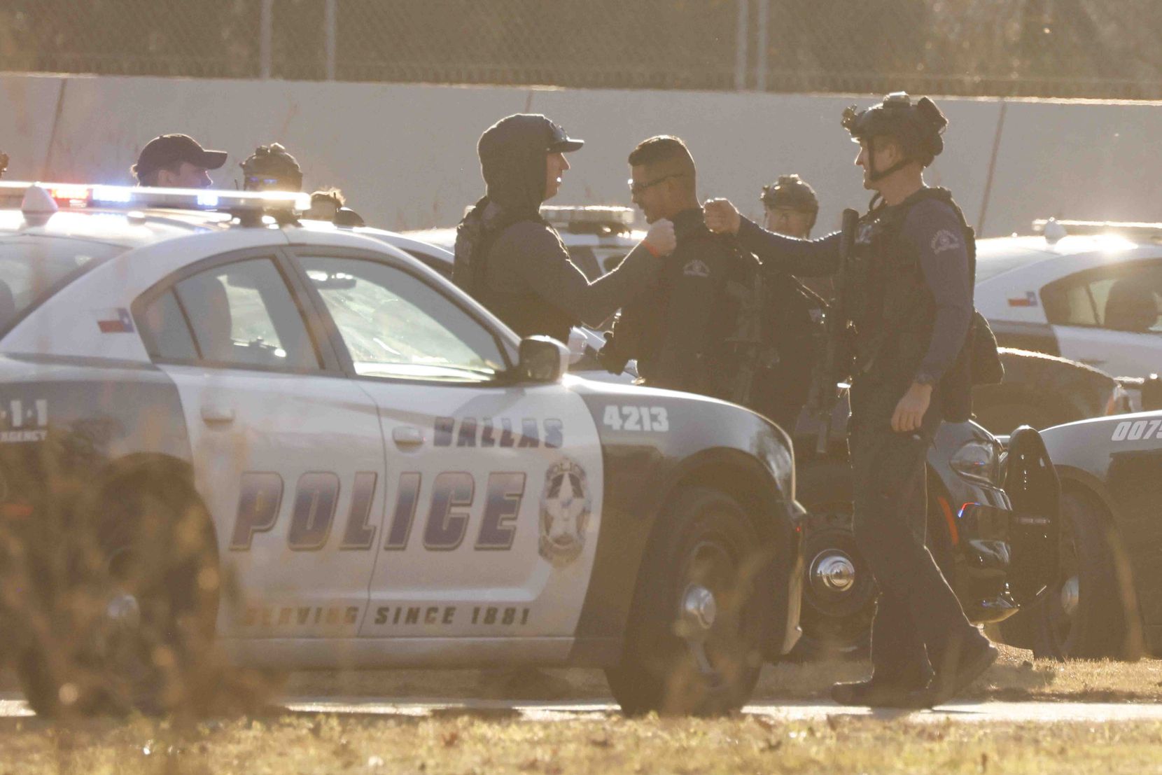 Police officers cheer after defusing an active scene near Keeton Park golf course on...