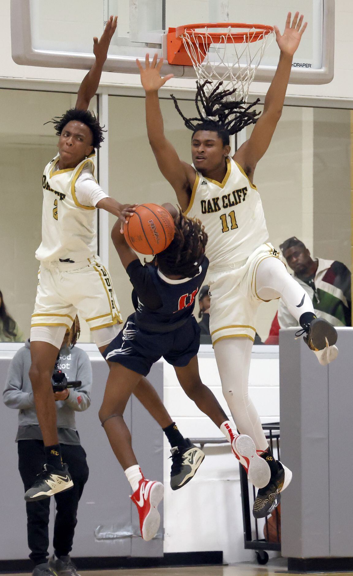 South Oak Cliff defenders Jabriel Muhammad (2), left, and Ian Black (11) team up to block a...