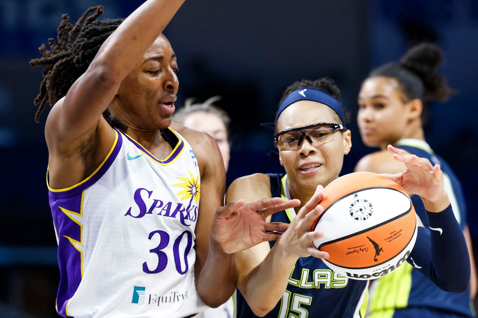 Dallas Wings guard Allisha Gray, right, and Los Angeles Sparks forward Nneka Ogwumike fights...
