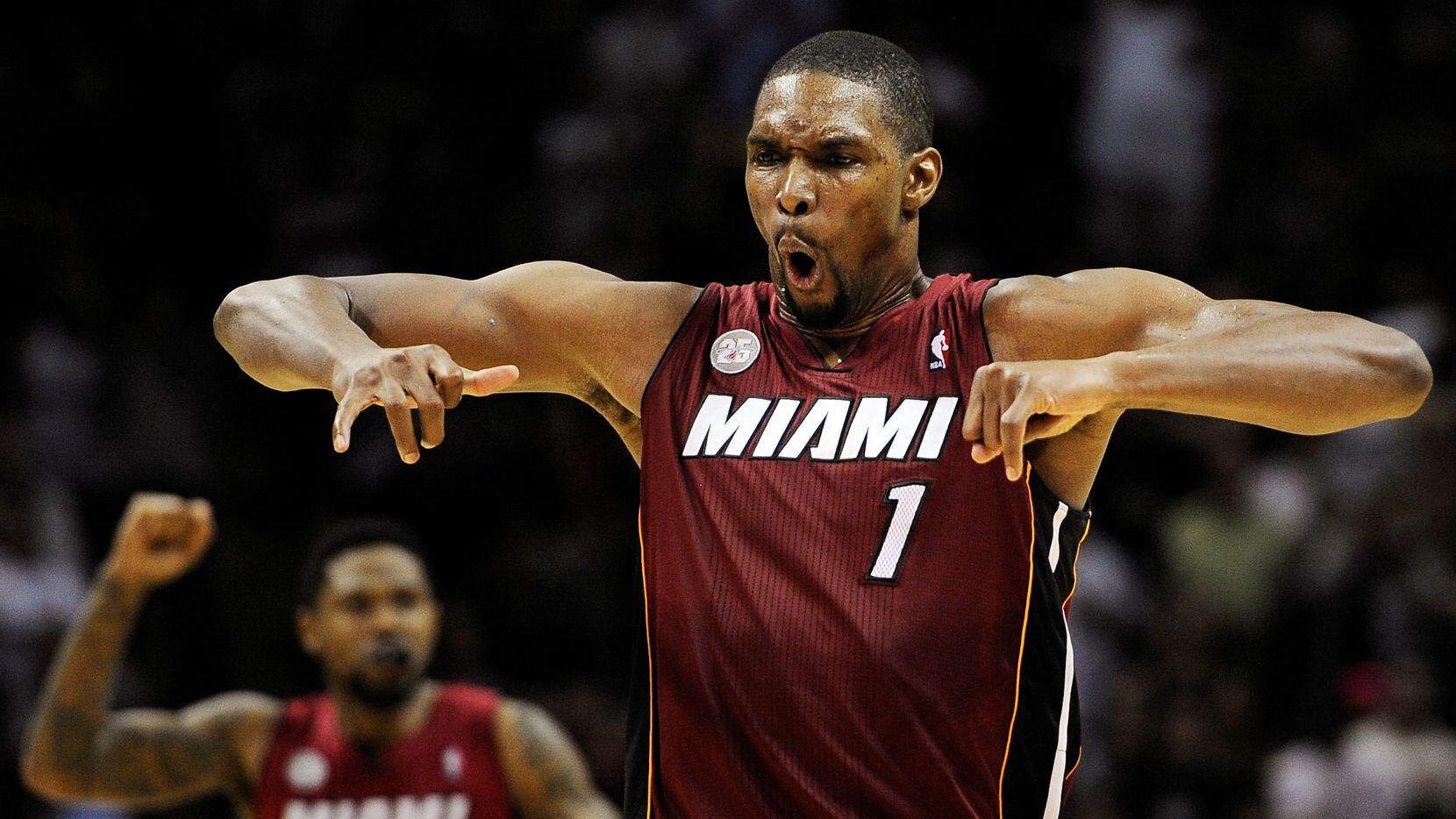 Miami Heat's Chris Bosh (1) yells after scoring the winning basket during the second half of...