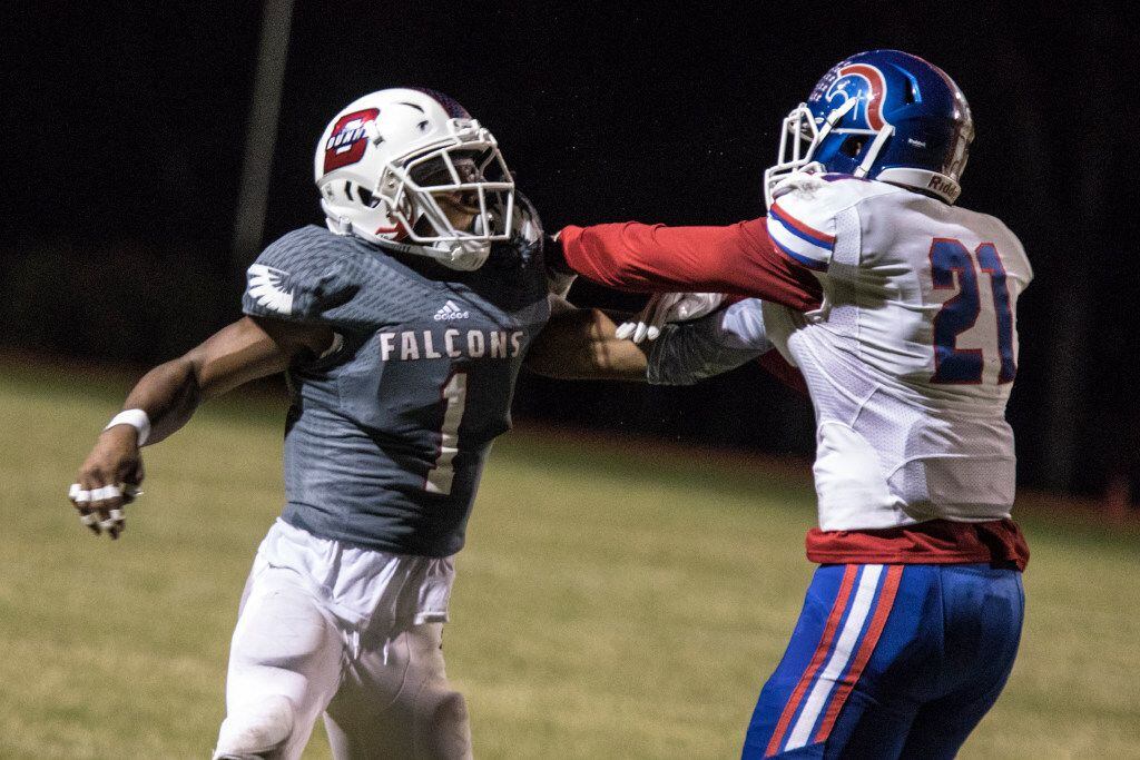 Bishop Dunne defensive back Chevin Calloway (1) battles for position with TCA wide receiver...