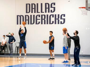 Dallas Mavericks guards Jalen Brunson, left, and Josh Green, right, participate in a...