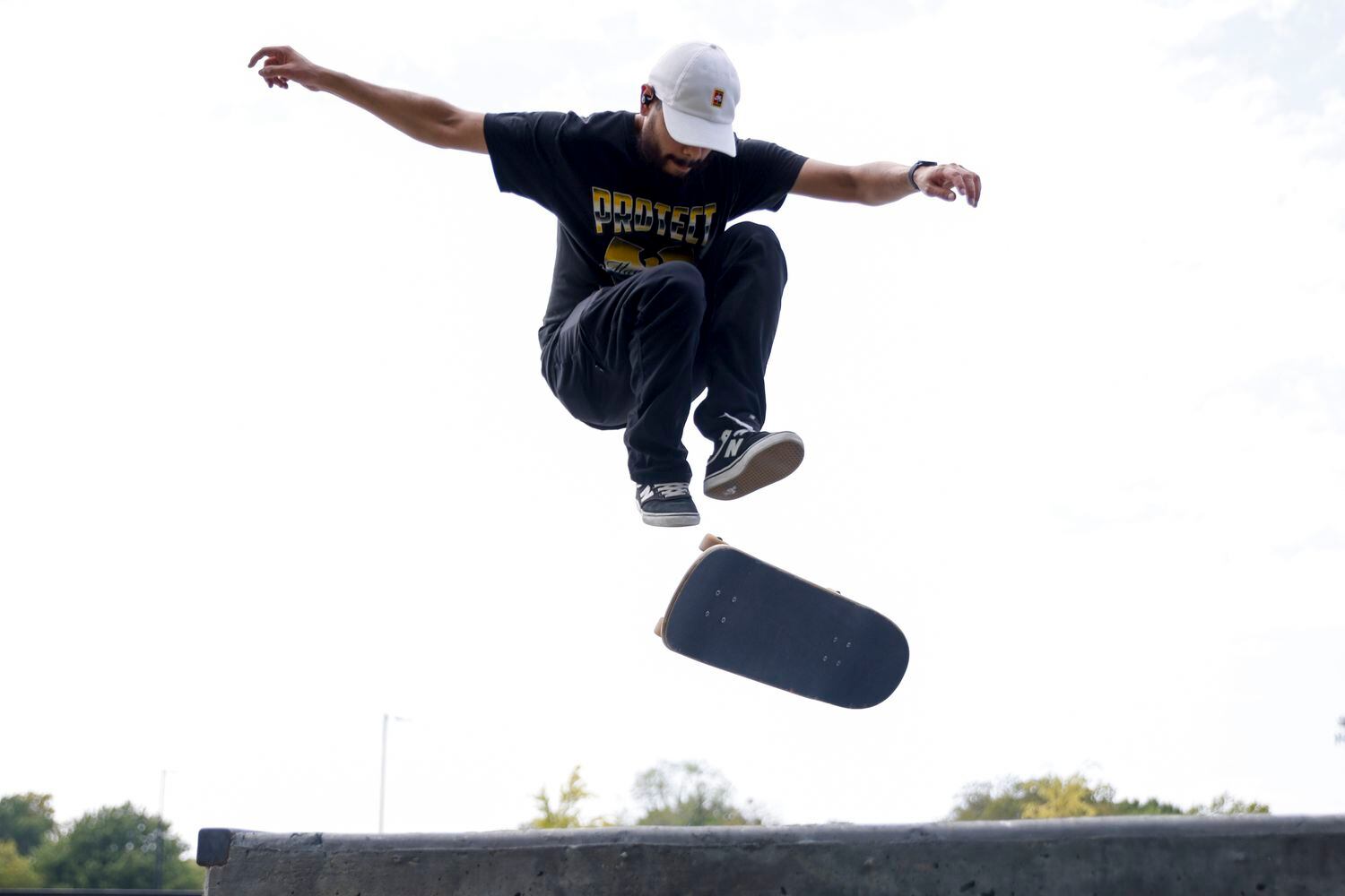 Isaac Contreras, 26, performs a trick as he skateboards at the Jon Comer Skatepark,...