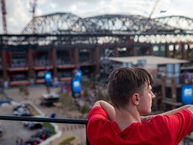 Connor Dill, 16 and from Arlington, looks out at the new Globe Life Field from the top level...