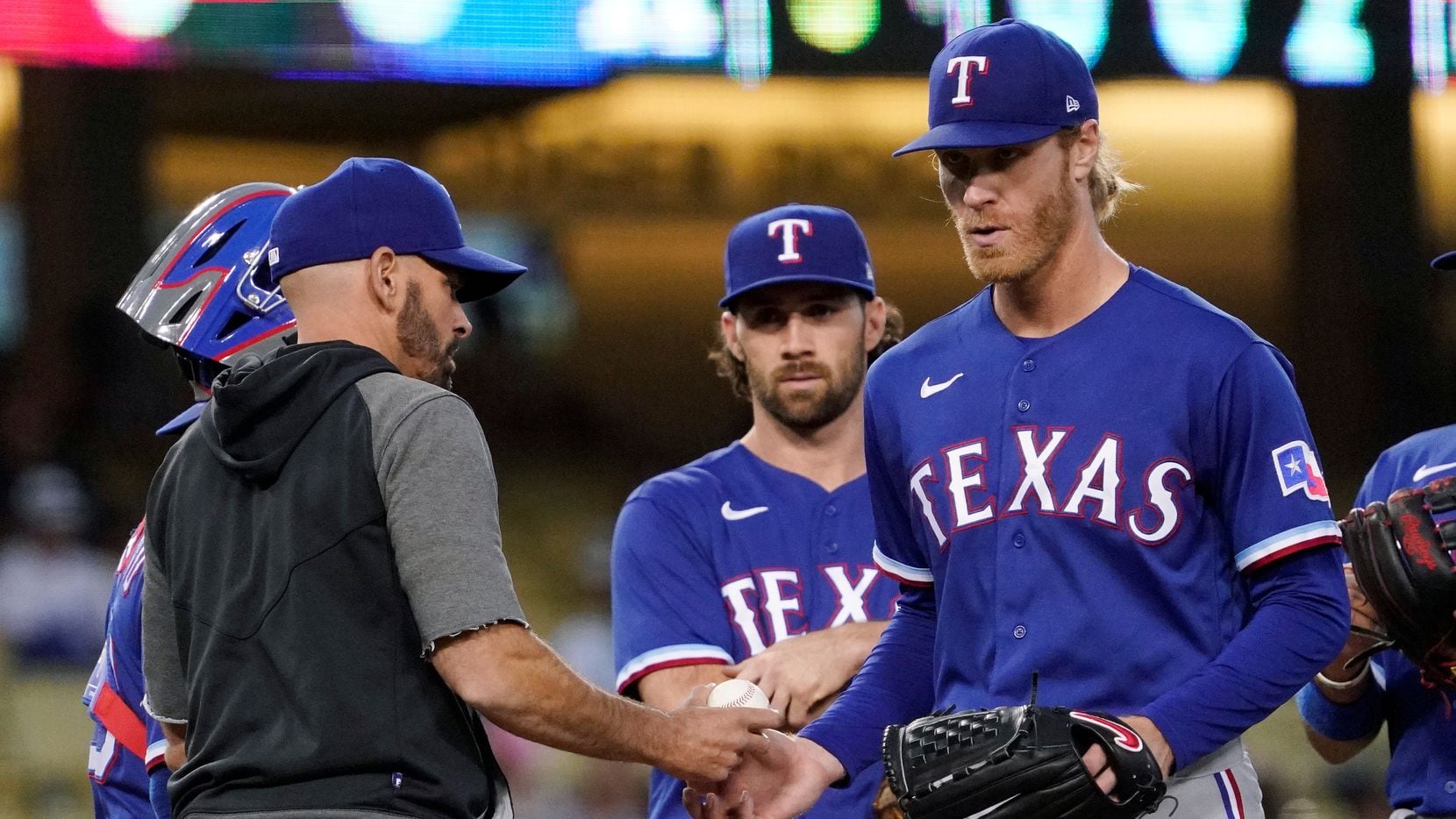 Texas Rangers starting pitcher Mike Foltynewicz, right, is taken out of the game by manager...