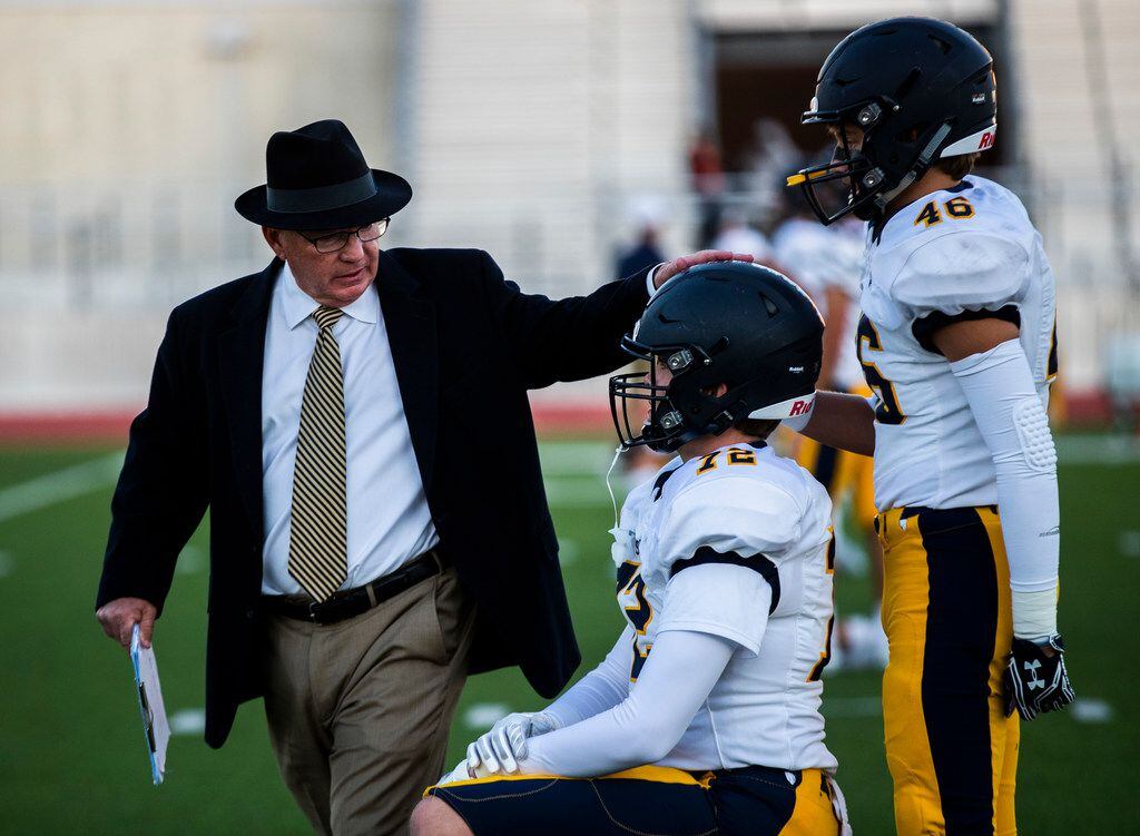 Highland Park head coach Randy Allen greets players as they warm up before a District 6-5A...