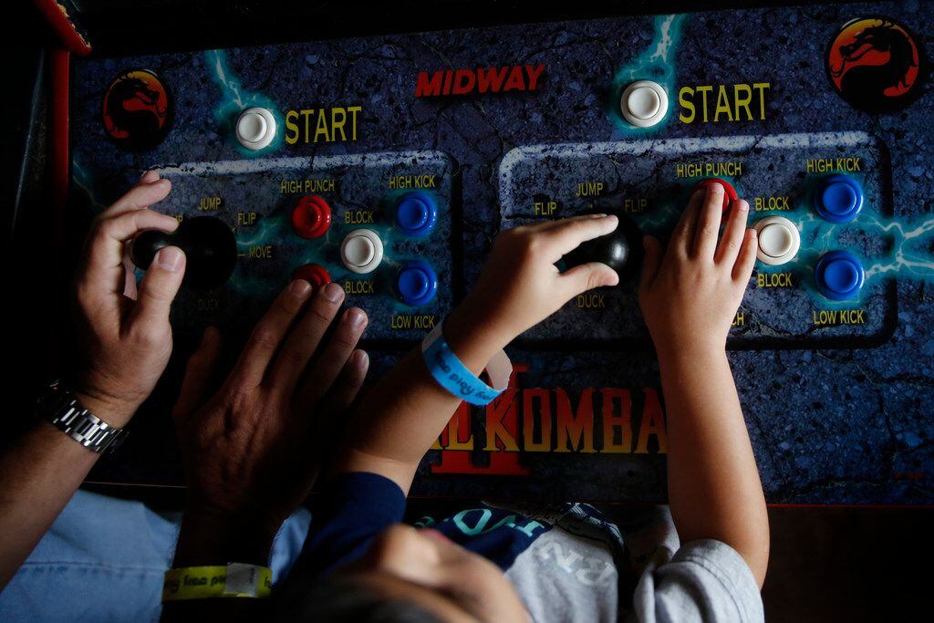 Jeff Wise (left) plays Mortal Kombat with his son Maxwell Wise, 4, at Free Play in Richardson.