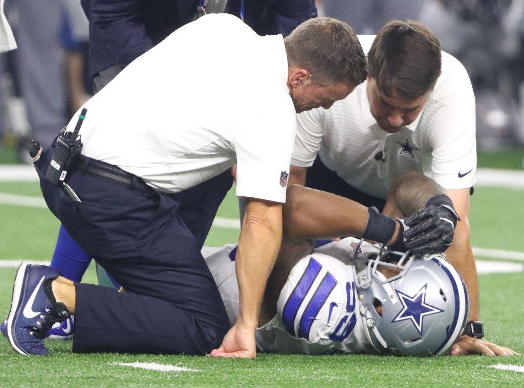 Dallas Cowboys Anthony Hitchens (59) is helped on the field after getting hurt during the...